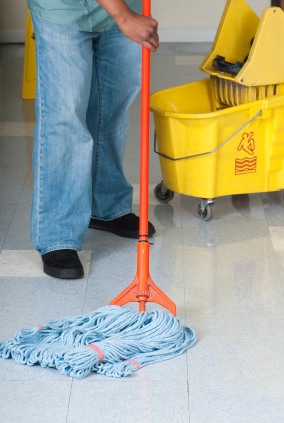 DJ's Cleaning LLC janitor in Largo, MD mopping floor.
